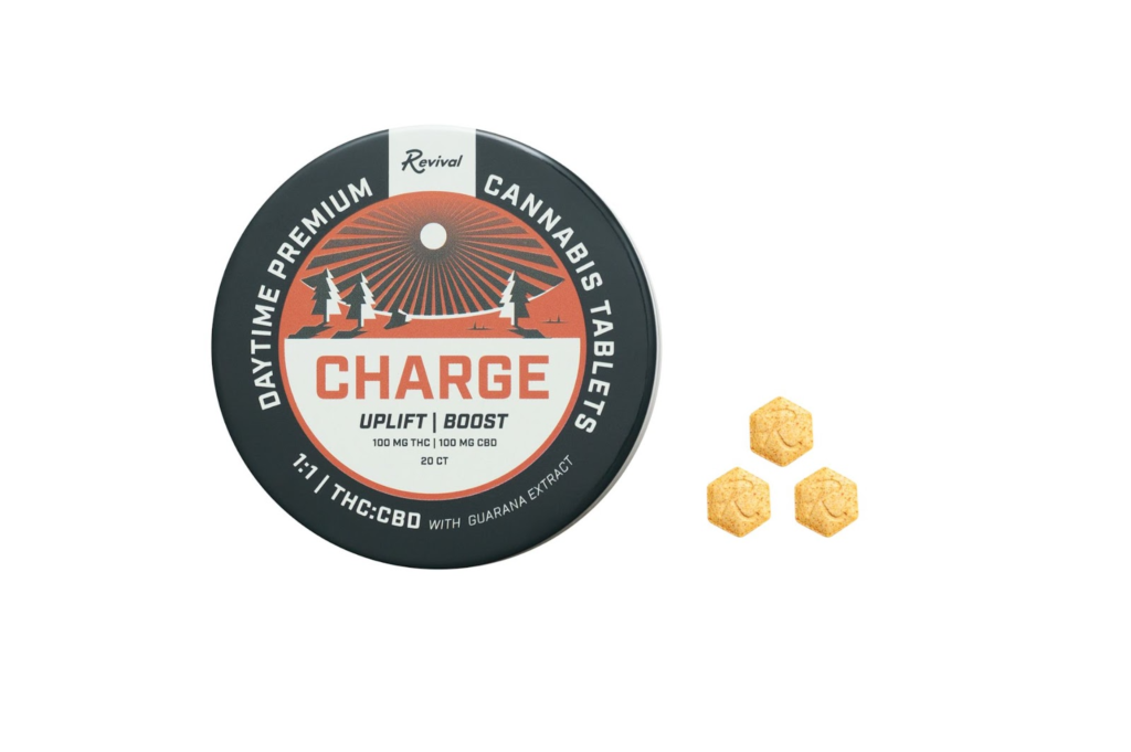 Revival Gems 'Charge' tablet tin and tablet displayed on a clean, off-white surface — showcasing the discreet, portable design of Revival’s full-spectrum, cannabis-infused tablets formulated for daytime energy and clarity. Features minimalist packaging with science-forward, lifestyle-driven branding