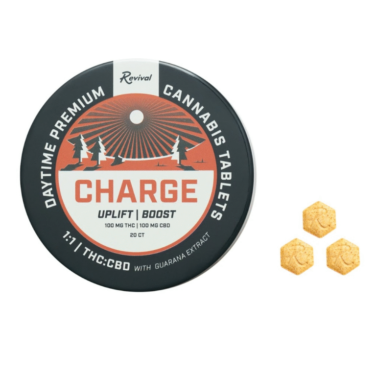 Revival Gems 'Charge' tablet tin and tablet displayed on a clean, off-white surface — showcasing the discreet, portable design of Revival’s full-spectrum, cannabis-infused tablets formulated for daytime energy and clarity. Features minimalist packaging with science-forward, lifestyle-driven branding