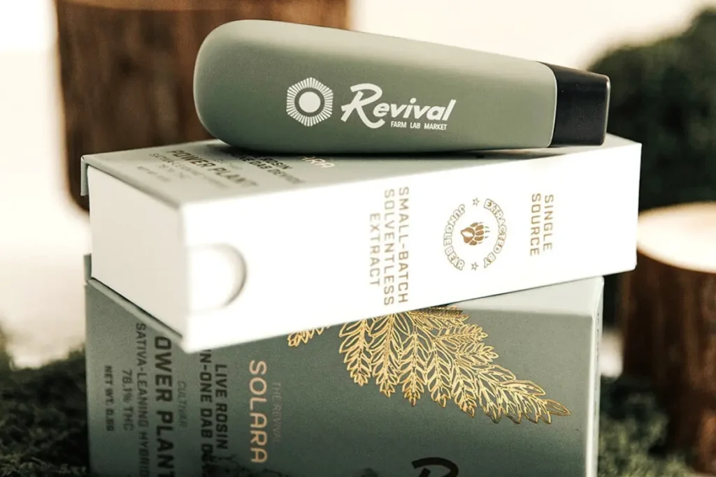 Revival’s Solara pocketable rosin dab device resting on branded packaging labeled small-batch solventless extract and single source. Revival is a locally made brand in Buffalo, NY. Flavor: Power Plant