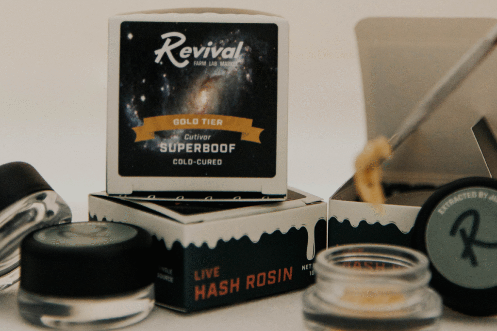 Revival Superboof live hash rosin packaging and jar displayed with cannabis concentrate tools, highlighting craft live rosin in Buffalo.