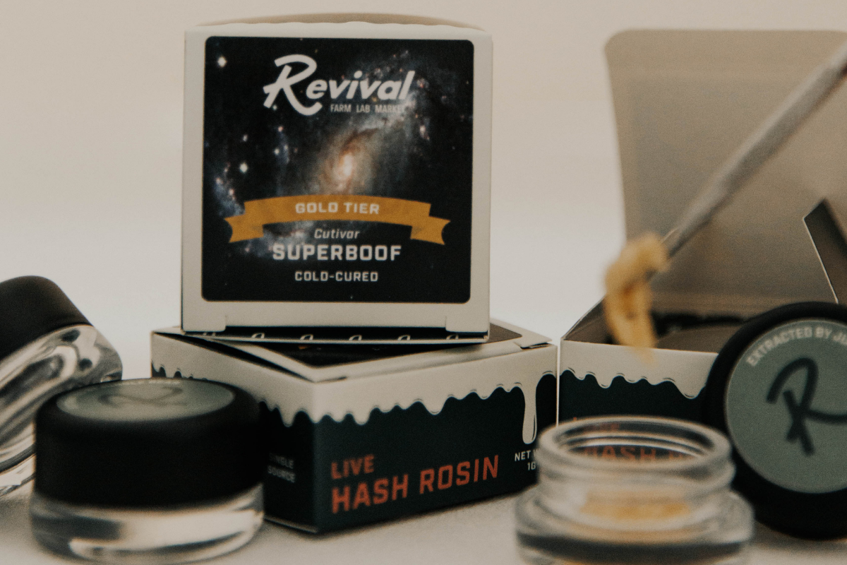 Revival Superboof live hash rosin packaging and jar displayed with cannabis concentrate tools, highlighting craft live rosin in Buffalo.
